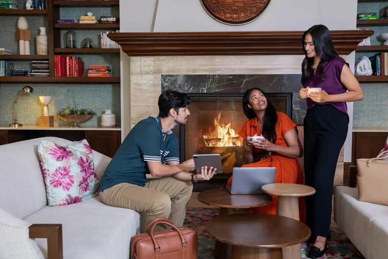 The Alfond Inn Lifestyle Friends Fireplace Lounge Coffee and Laptops Photography by Greg Ceo Studio Retouching by Valentin Sivyakov