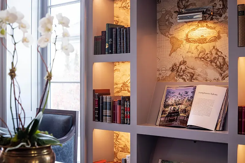 Keswick Hall Keswick Hall Library Bookshelf Detail Illuminated Nooks Antique Map Backdrops Art Book Keswick Virginia Luxury Resort Photography Greg Ceo Studio Retouching by Valentin Sivyakov
